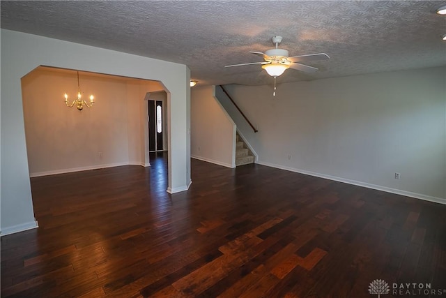 2710 Zoellners Way, Fairfield Twp, OH 45011 - spare room with arched walkways, stairs, wood finished floors, ceiling fan, and a chandelier