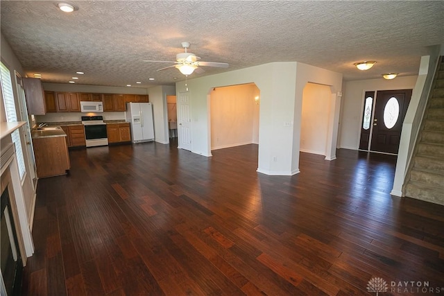 2710 Zoellners Way, Fairfield Twp, OH 45011 - unfurnished living room featuring ceiling fan, dark wood-style flooring, arched walkways, plenty of natural light, and recessed lighting