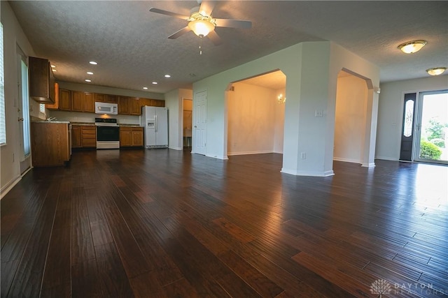 2710 Zoellners Way, Fairfield Twp, OH 45011 - unfurnished living room featuring dark wood-style floors, a textured ceiling, a ceiling fan, arched walkways, and recessed lighting