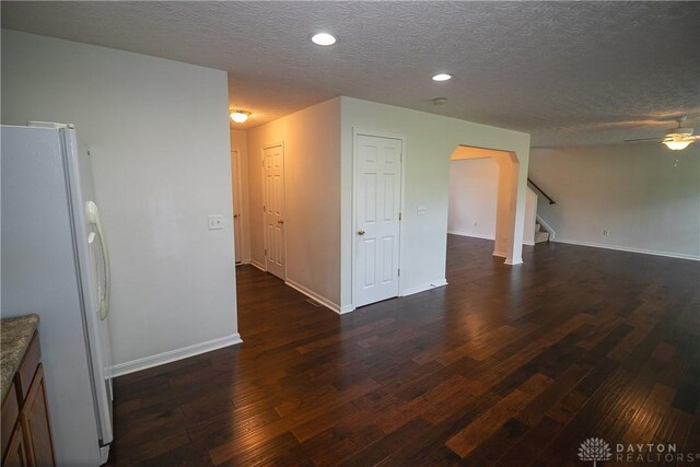 2710 Zoellners Way, Fairfield Twp, OH 45011 - empty room with arched walkways, wood finished floors, ceiling fan, a textured ceiling, and stairs