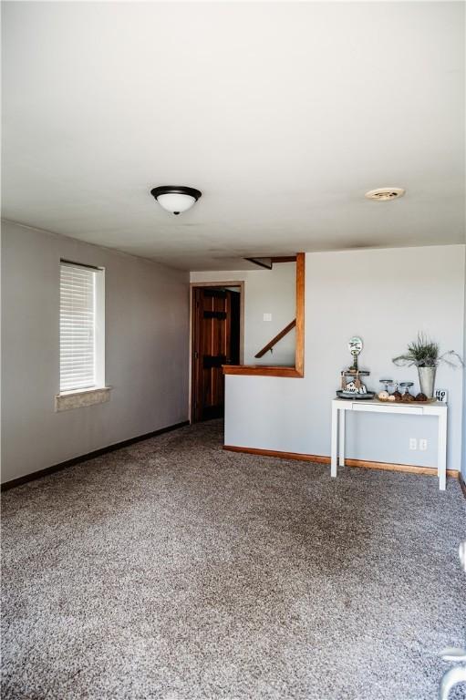 916 Wilson Rd, Troy, OH 45373 - unfurnished living room featuring carpet floors and baseboards