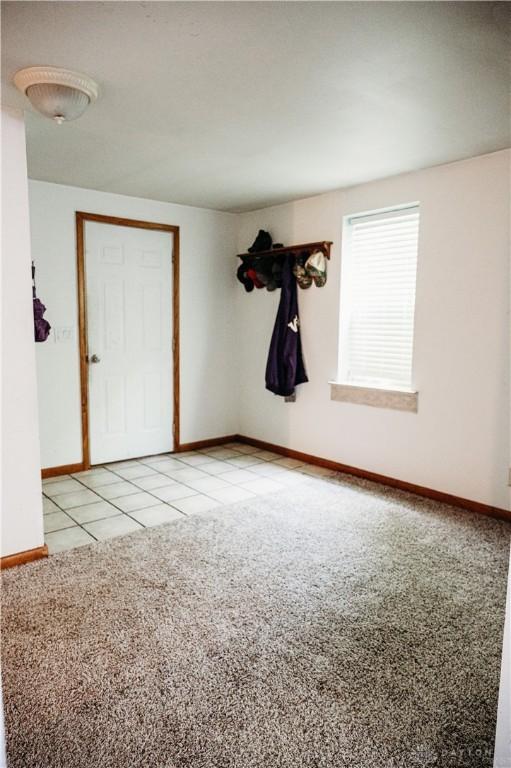 916 Wilson Rd, Troy, OH 45373 - empty room featuring light carpet and light tile patterned floors