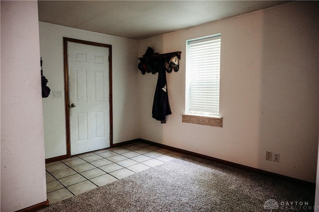 916 Wilson Rd, Troy, OH 45373 - spare room with light carpet and light tile patterned floors