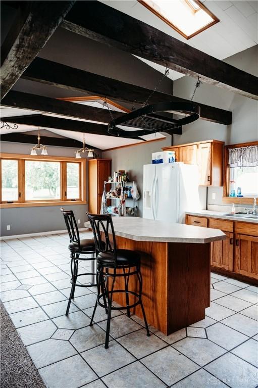 916 Wilson Rd, Troy, OH 45373 - kitchen featuring white refrigerator with ice dispenser, light countertops, and plenty of natural light