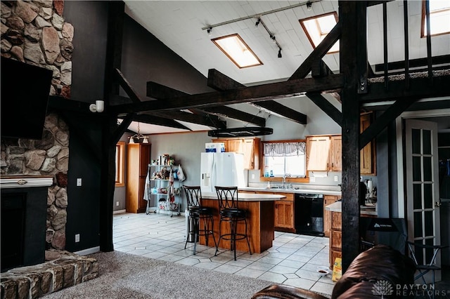 916 Wilson Rd, Troy, OH 45373 - kitchen with dishwasher, white fridge with ice dispenser, a kitchen island, rail lighting, and light countertops