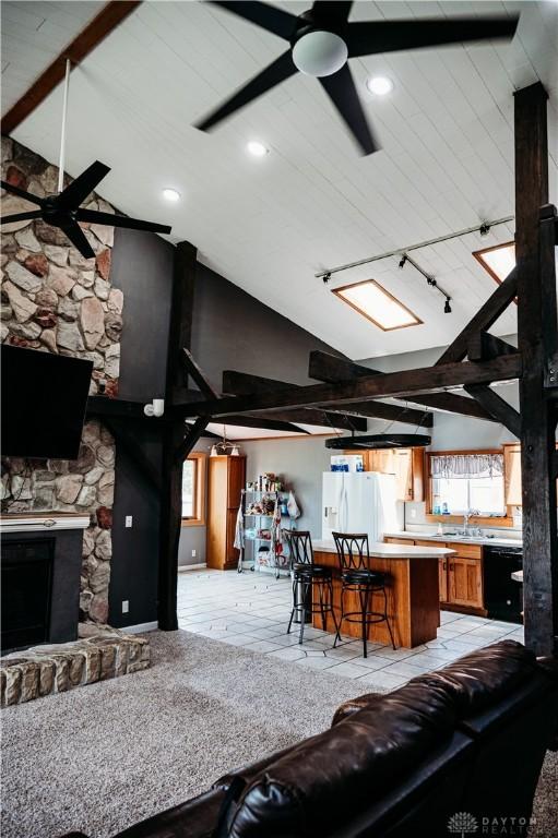916 Wilson Rd, Troy, OH 45373 - living area with a ceiling fan, recessed lighting, high vaulted ceiling, and a stone fireplace