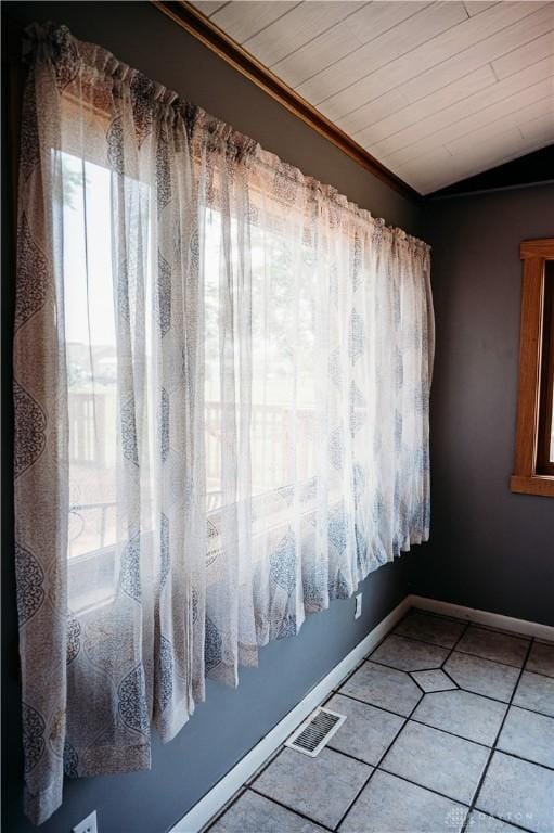 916 Wilson Rd, Troy, OH 45373 - unfurnished room featuring plenty of natural light, light tile patterned flooring, and vaulted ceiling