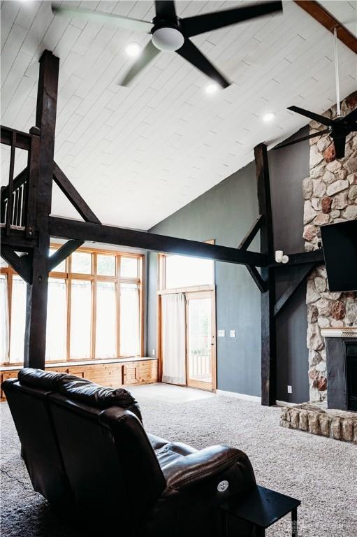 916 Wilson Rd, Troy, OH 45373 - carpeted living room with ceiling fan, a fireplace, and high vaulted ceiling