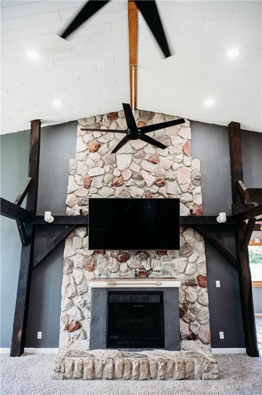916 Wilson Rd, Troy, OH 45373 - detailed view of beamed ceiling, a ceiling fan, a fireplace, and carpet flooring