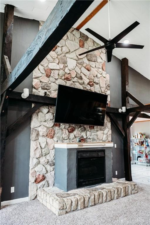 916 Wilson Rd, Troy, OH 45373 - detailed view of a fireplace, ceiling fan, beam ceiling, and carpet