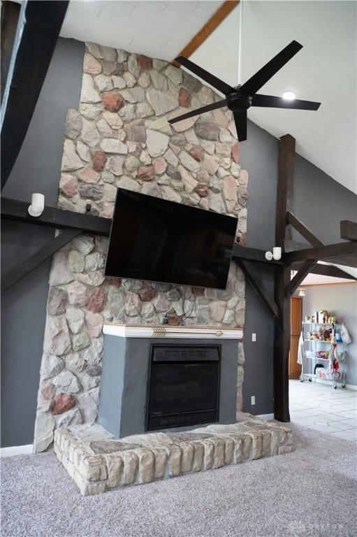 916 Wilson Rd, Troy, OH 45373 - detailed view of a fireplace with raised hearth, ceiling fan, and carpet floors