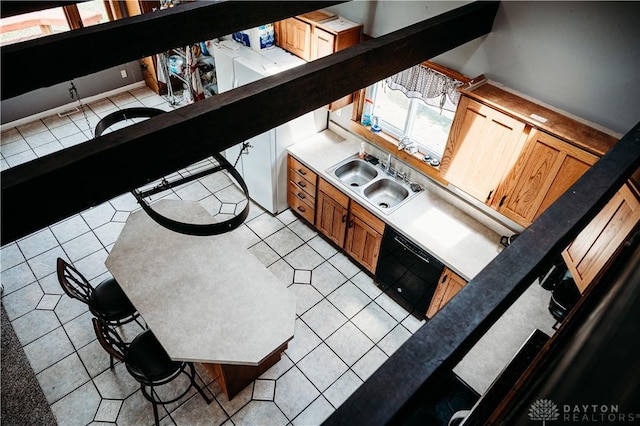 916 Wilson Rd, Troy, OH 45373 - kitchen featuring light tile patterned floors and brown cabinets