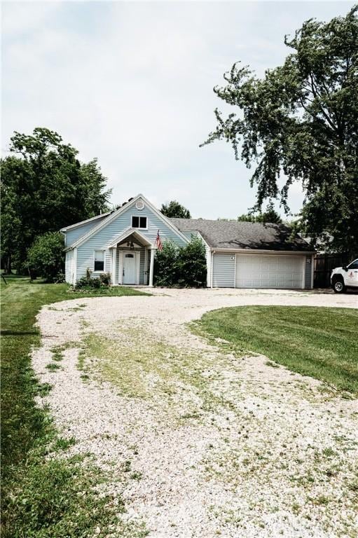 916 Wilson Rd, Troy, OH 45373 - view of front of house with driveway, a front yard, and an attached garage