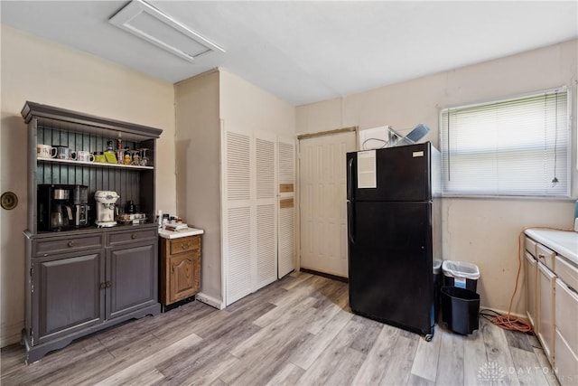 711 E 2nd St, Xenia, OH 45385 - kitchen with freestanding refrigerator, light wood-style floors, and open shelves