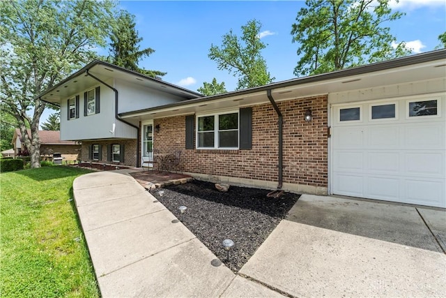416 Bent Twig Dr, Vandalia, OH 45377 - tri-level home with an attached garage, brick siding, a front yard, and concrete driveway