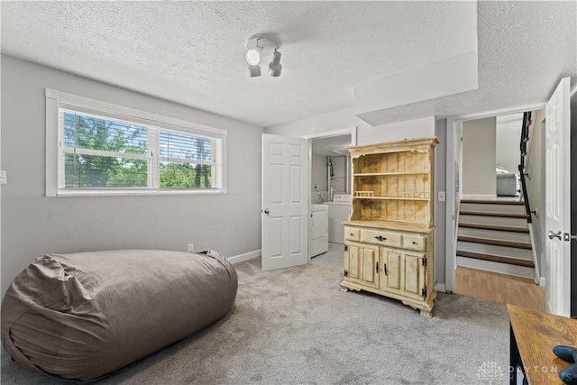 416 Bent Twig Dr, Vandalia, OH 45377 - sitting room featuring a textured ceiling, washer and dryer, light carpet, and stairway