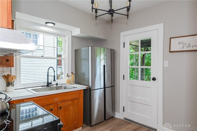 331 Illinois Ave, Dayton, OH 45410 - kitchen featuring freestanding refrigerator, a chandelier, light countertops, brown cabinets, and light wood finished floors