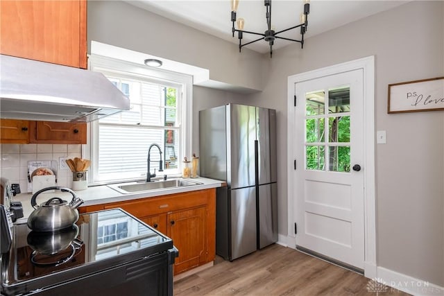 331 Illinois Ave, Dayton, OH 45410 - kitchen with freestanding refrigerator, extractor fan, a chandelier, and brown cabinets