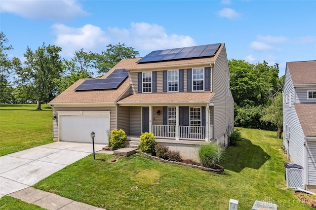 110 Easton Manor Dr, Monroe, OH 45050 - traditional home featuring covered porch, roof mounted solar panels, a garage, a front lawn, and concrete driveway