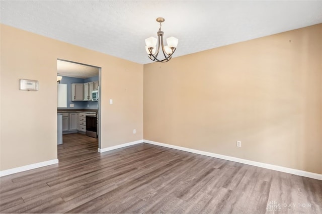 110 Easton Manor Dr, Monroe, OH 45050 - unfurnished room with dark wood-style flooring and a chandelier