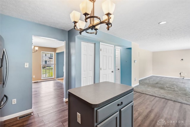 110 Easton Manor Dr, Monroe, OH 45050 - kitchen featuring a textured ceiling, a chandelier, open floor plan, and dark wood-style floors