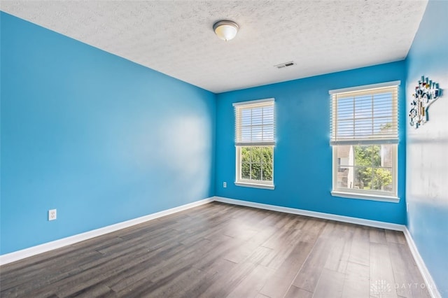 110 Easton Manor Dr, Monroe, OH 45050 - spare room featuring plenty of natural light, wood finished floors, and a textured ceiling