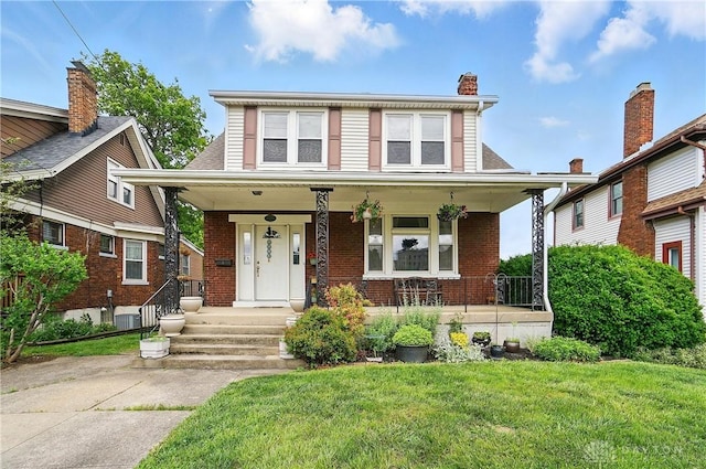 2344 Quatman Ave, Norwood, OH 45212 - view of front of property with a porch, brick siding, and a front yard