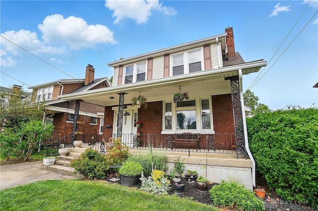 2344 Quatman Ave, Norwood, OH 45212 - view of front of house with a porch, brick siding, and a chimney