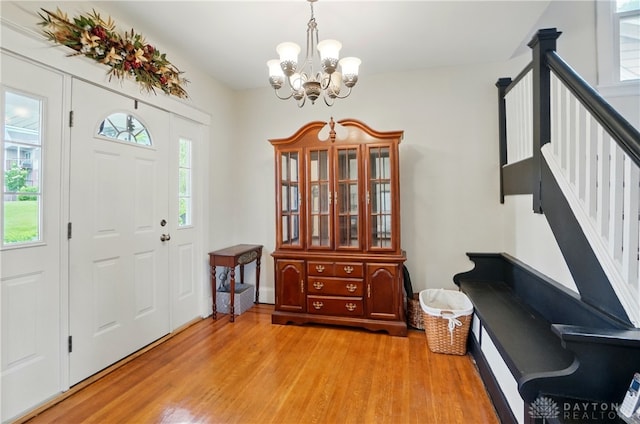 2344 Quatman Ave, Norwood, OH 45212 - foyer featuring light wood finished floors, a chandelier, and stairway