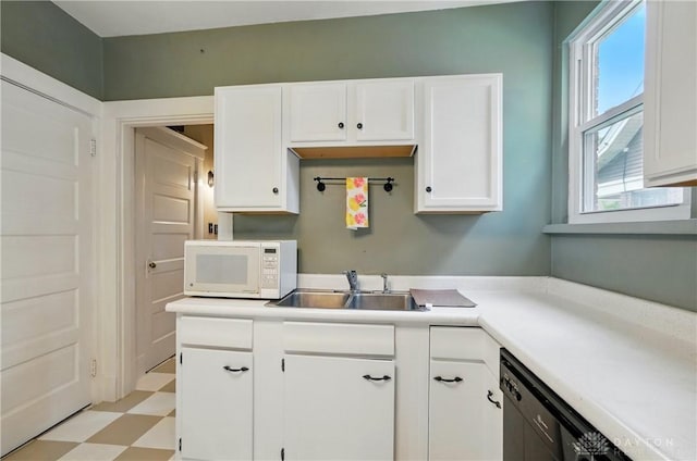2344 Quatman Ave, Norwood, OH 45212 - kitchen with white microwave, light flooring, white cabinetry, light countertops, and dishwasher