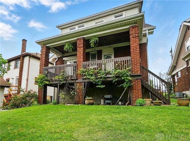 2344 Quatman Ave, Norwood, OH 45212 - rear view of property featuring a yard, brick siding, stairway, and a porch