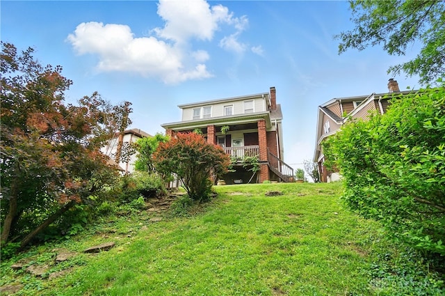 2344 Quatman Ave, Norwood, OH 45212 - rear view of property featuring a yard, stairs, covered porch, and brick siding