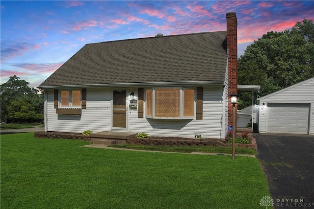 400 S Hayden Ave, Riverside, OH 45431 - view of front of house with a front lawn, asphalt driveway, a chimney, an outdoor structure, and a shingled roof