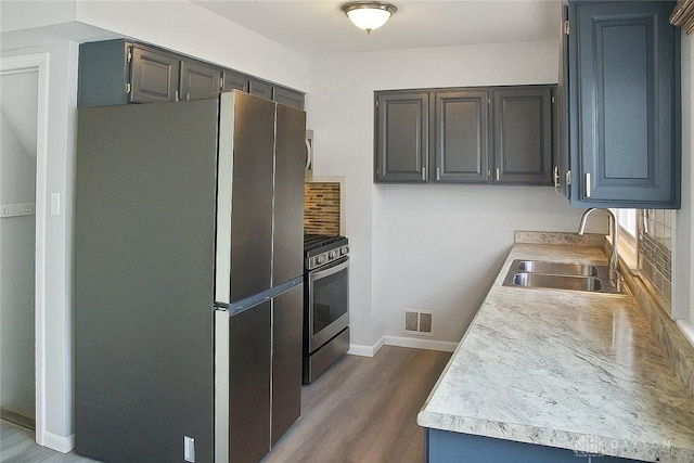 400 S Hayden Ave, Riverside, OH 45431 - kitchen featuring stainless steel appliances, wood finished floors, light countertops, and decorative backsplash