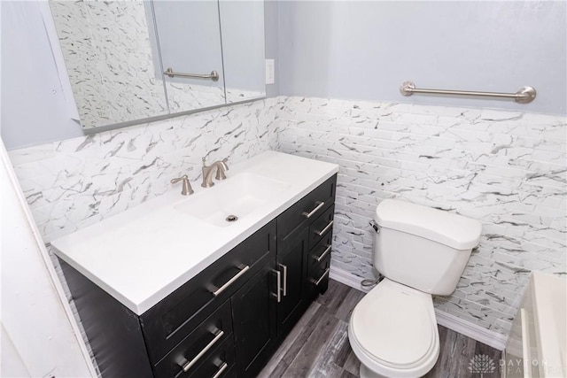 4155 Eckworth, Bellbrook, OH 45305 - bathroom featuring tile walls, vanity, wood finished floors, wainscoting, and a bathtub