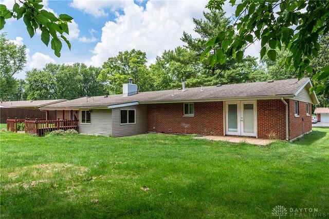 4155 Eckworth, Bellbrook, OH 45305 - rear view of property with brick siding, a wooden deck, a lawn, and french doors