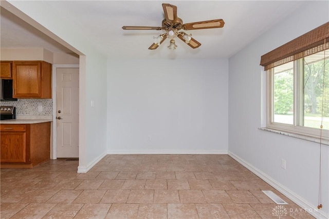 4155 Eckworth, Bellbrook, OH 45305 - unfurnished dining area featuring a ceiling fan and light stone finish flooring