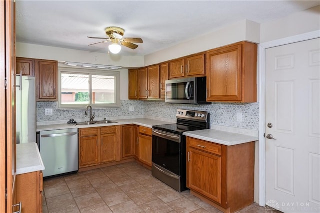 4155 Eckworth, Bellbrook, OH 45305 - kitchen with appliances with stainless steel finishes, a ceiling fan, brown cabinetry, light countertops, and tasteful backsplash