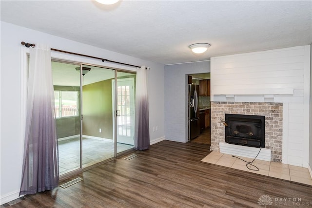 4155 Eckworth, Bellbrook, OH 45305 - unfurnished living room with wood finished floors and a brick fireplace