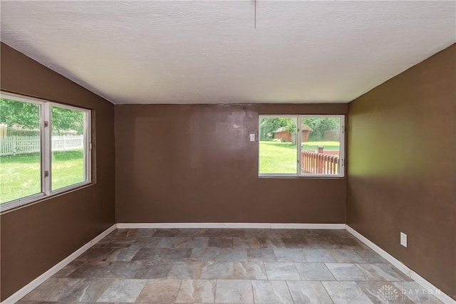 4155 Eckworth, Bellbrook, OH 45305 - empty room with healthy amount of natural light, stone finish flooring, and lofted ceiling