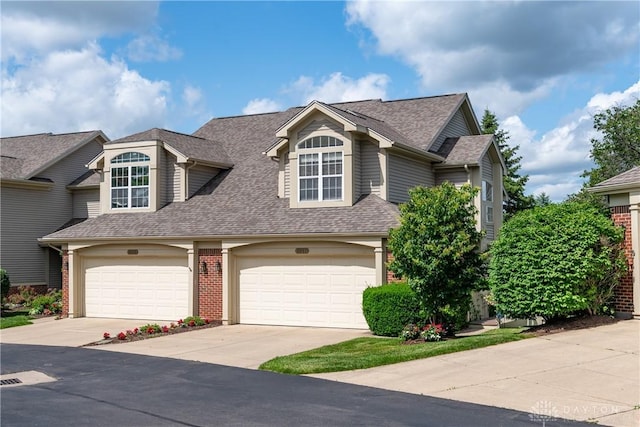 3917 E Summit Ridge Dr, Beavercreek, OH 45430 - view of front of house featuring a shingled roof, driveway, and a garage