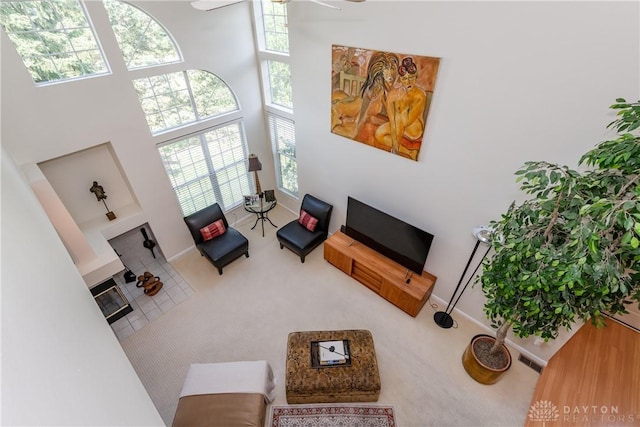 3917 E Summit Ridge Dr, Beavercreek, OH 45430 - living area with a towering ceiling, ceiling fan, and carpet