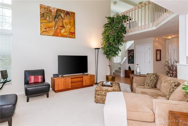3917 E Summit Ridge Dr, Beavercreek, OH 45430 - living area with a high ceiling, stairway, and light carpet