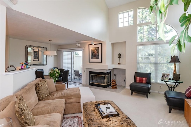 3917 E Summit Ridge Dr, Beavercreek, OH 45430 - carpeted living room featuring a fireplace and a high ceiling