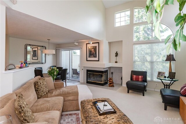 3917 E Summit Ridge Dr, Beavercreek, OH 45430 - carpeted living room featuring a fireplace and a high ceiling