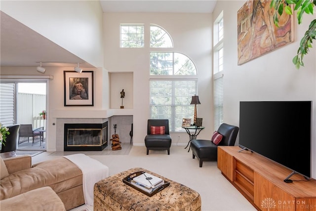 3917 E Summit Ridge Dr, Beavercreek, OH 45430 - living room with carpet flooring, a tiled fireplace, and a high ceiling