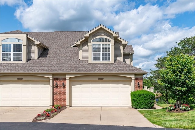 3917 E Summit Ridge Dr, Beavercreek, OH 45430 - view of front facade with concrete driveway, roof with shingles, brick siding, and a garage