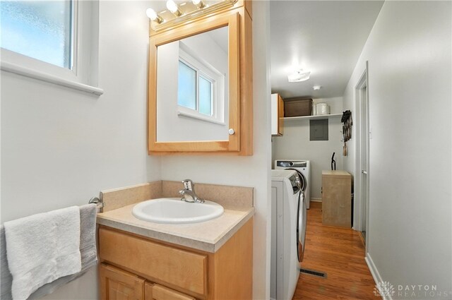 903 Meadow Ln, Lebanon, OH 45036 - bathroom featuring independent washer and dryer, wood finished floors, healthy amount of natural light, and vanity