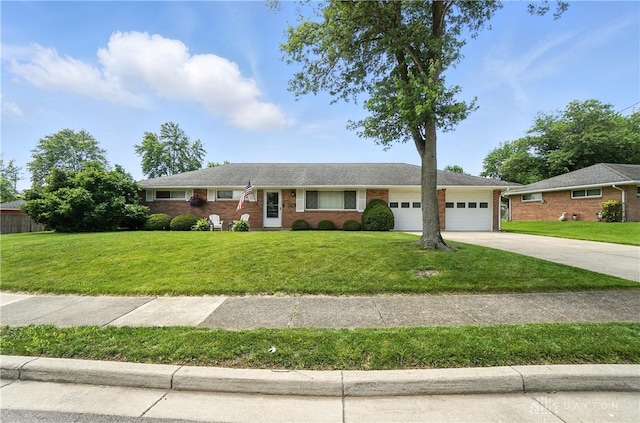 903 Meadow Ln, Lebanon, OH 45036 - ranch-style house with a garage, driveway, a front lawn, and brick siding