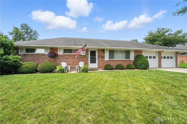 903 Meadow Ln, Lebanon, OH 45036 - ranch-style house featuring a garage, brick siding, a front lawn, and concrete driveway